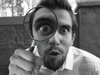 Image of researcher with magnifying glass.